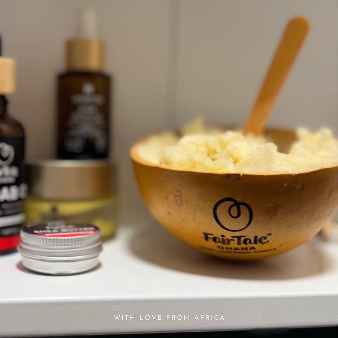 FairTale GHANA calabash bowl filled with Shea butter beside two Baobab oil bottles